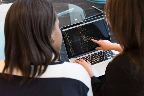 13. How Outsourcing Software Engineering Can Boost Your Business Two people discussing